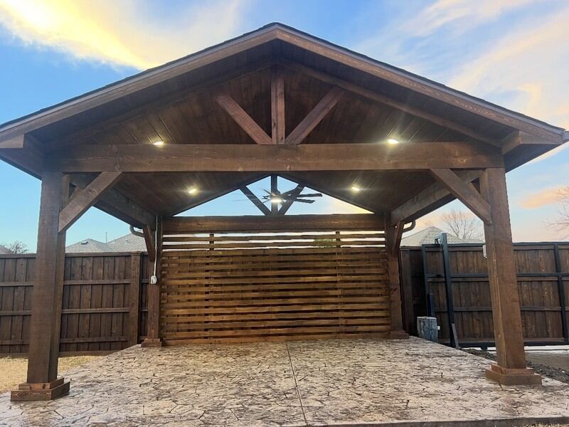 Cedar pavilion with integrated lighting over a stamped concrete patio